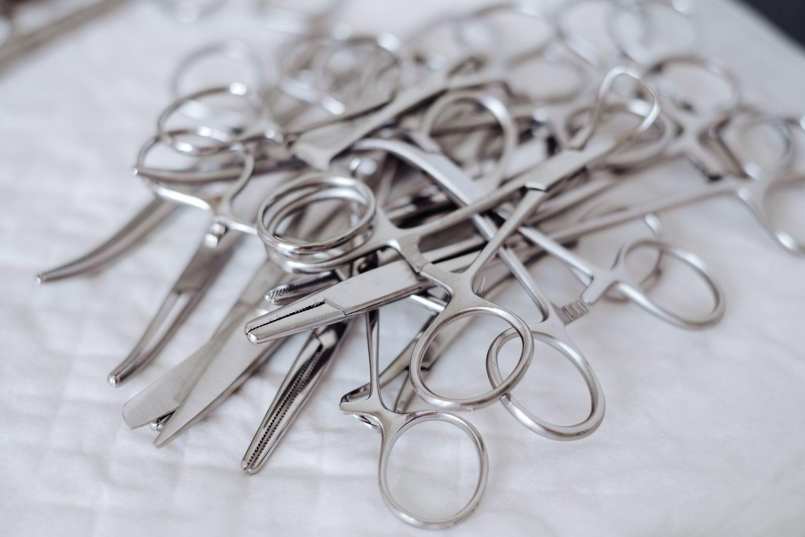 Surgical clamps and scissors on a sterile cloth
